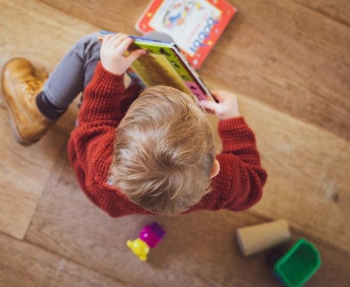 Children painting on hardwood flooring